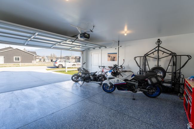 Garage featuring a garage door opener and a residential view | Image 20