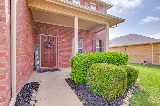 Doorway to property featuring nice and quaint front porch. | Image 34