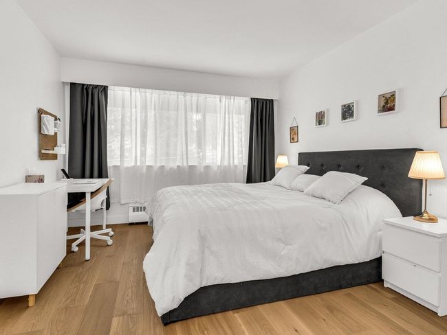Bedroom with wood finished floors and a baseboard heating unit | Image 20