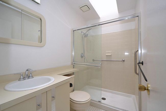 Full bath featuring vanity, toilet, tile patterned flooring, and a shower stall | Image 16