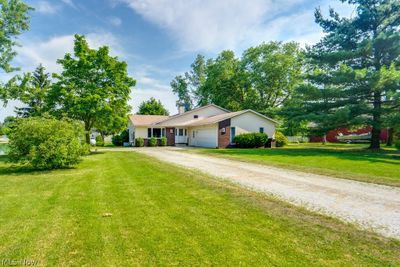 Single story home with a front lawn and a garage | Image 2