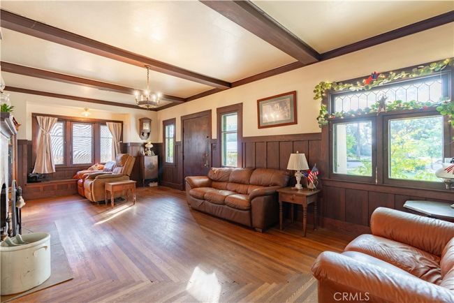 Rich millwork, hardwood floors, and natural light create a welcoming central living space. | Image 4
