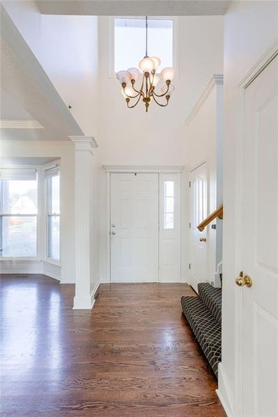 Foyer with a chandelier, plenty of natural light, a towering ceiling, and hardwood flooring | Image 2