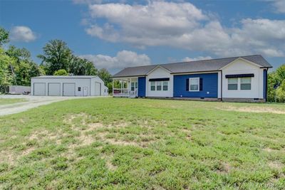 Single story home featuring an outbuilding. | Image 1