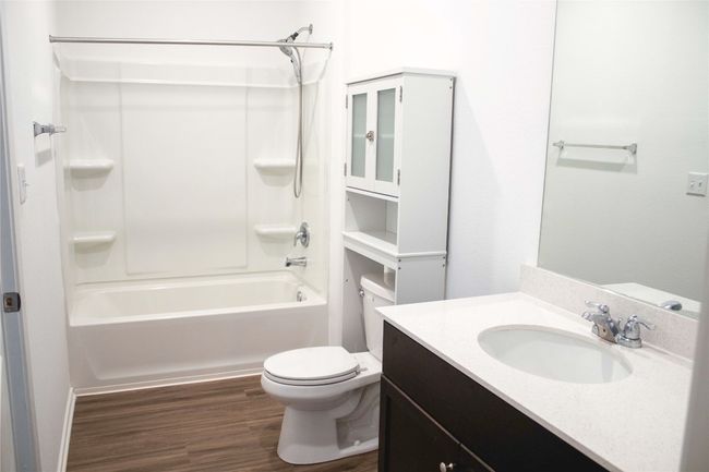 Primary Full bath featuring vanity, shower / bath combination, and wood finished floors | Image 10