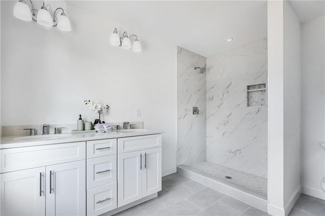 Unit #1: Left side, master bathroom with shower and double sinks. | Image 10