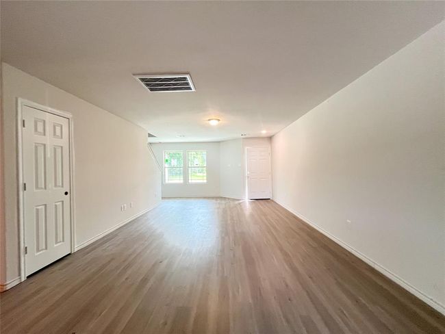 Expansive open-concept living area with abundant natural light, perfect for modern living and entertaining. | Image 4