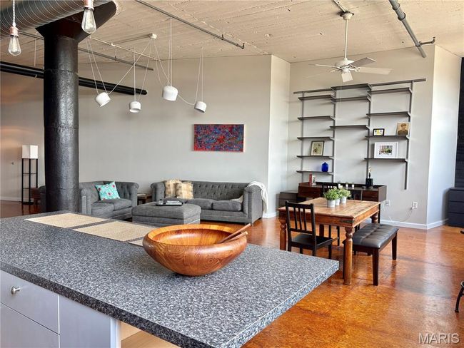 Living area featuring ceiling fan and a high ceiling | Image 13