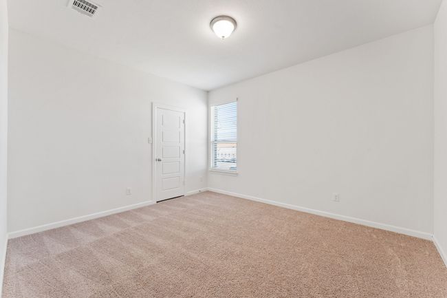 Empty room featuring light colored carpet, visible vents, and baseboards | Image 17