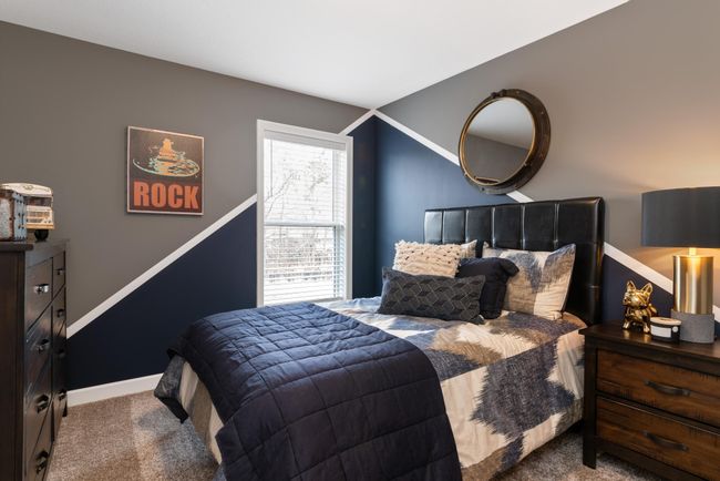 (Photo of decorated model, actual home's finishes will vary) One of three generously sized secondary bedrooms. | Image 16
