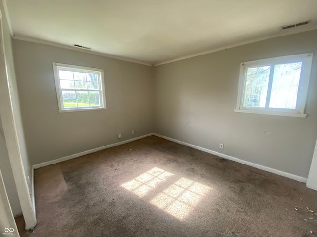 carpeted empty room featuring visible vents, crown molding, and baseboards | Image 11