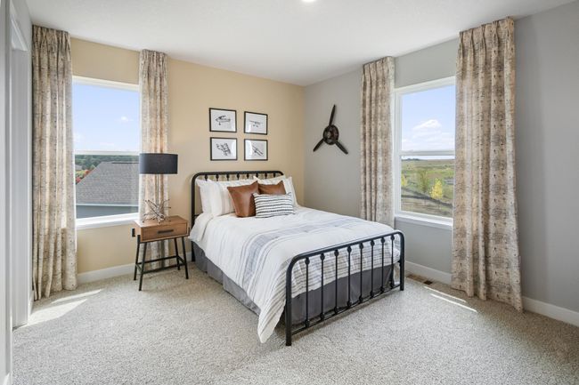 Each of the spacious secondary bedrooms feature well thought out window locations and a walk-in closet. Model photo. Options and colors will vary. | Image 21
