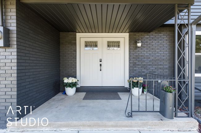 View of exterior entry featuring covered porch and brick siding | Image 4