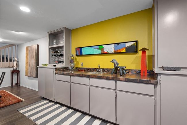 Wet Bar area with wine rack, sink, cabinetry off of living and dining. | Image 15