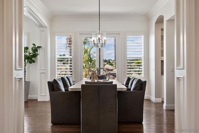 Dining room with double doors leading to the resort style backyard. | Image 16