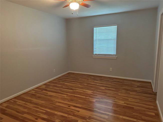 Unfurnished room featuring baseboards, wood finished floors, and a ceiling fan | Image 11
