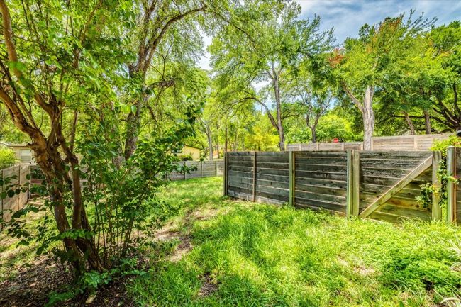 View of fenced backyard | Image 25