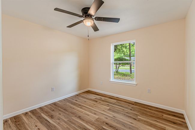 Empty room featuring baseboards, a ceiling fan, and wood finished floors | Image 21