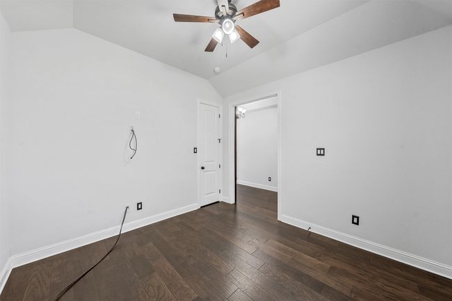Unfurnished room featuring lofted ceiling, ceiling fan, and wood finished floors | Image 28