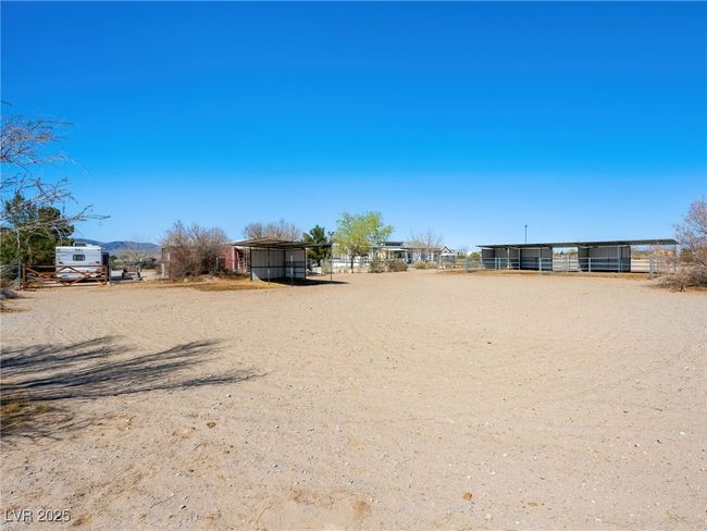 View of yard featuring a carport, an outdoor structure, and fence | Image 58