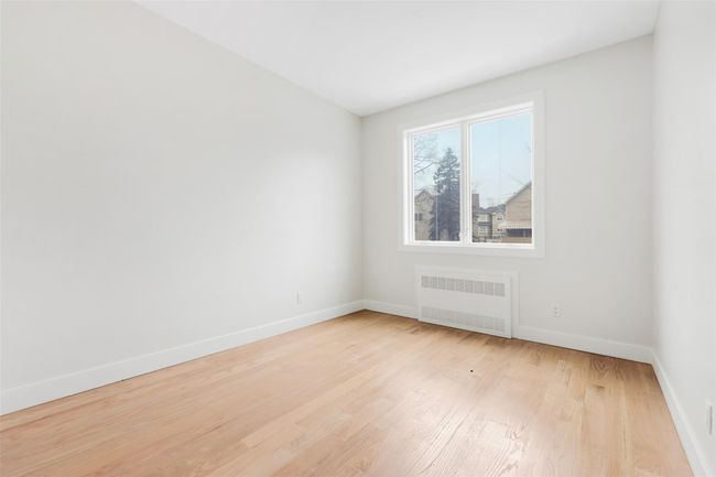 Spare room featuring light hardwood / wood-style flooring and radiator | Image 20