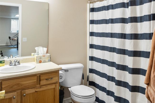 Bathroom with vanity and a shower with shower curtain | Image 39