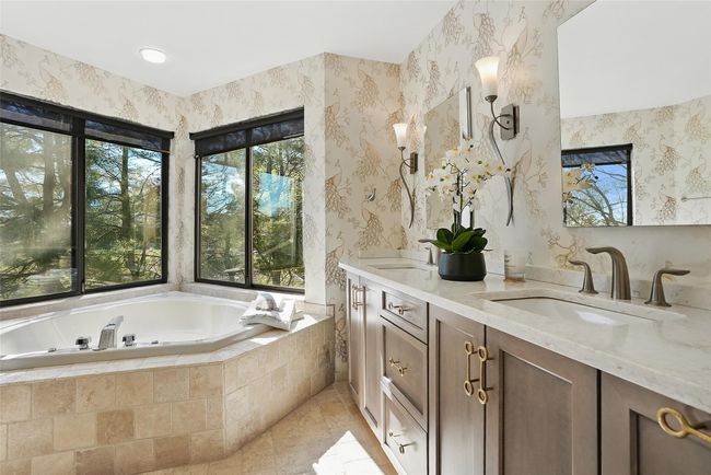 Spa bath has been recently updated. New double sink vanity, mirror and lighting enhance this room. | Image 20