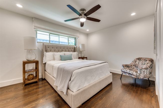 Bedroom featuring dark wood-type flooring, baseboards, recessed lighting, and ceiling fan | Image 20