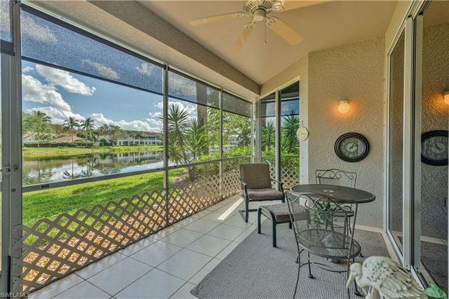 Sunroom with ceiling fan and a water view | Image 8