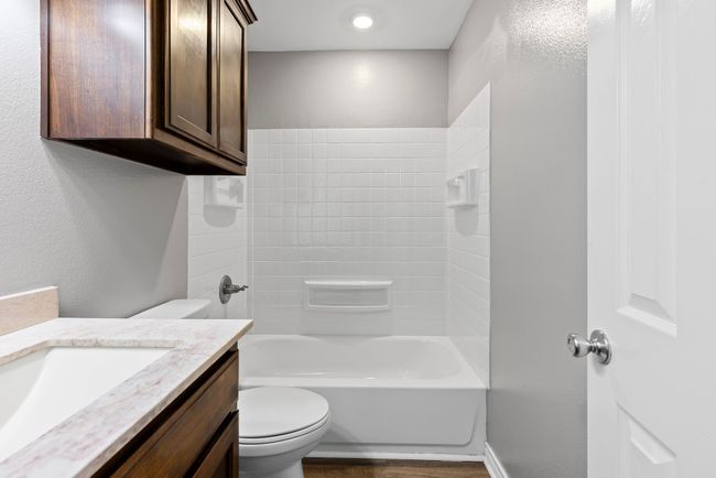 Bathroom featuring vanity and tub / shower combination | Image 19