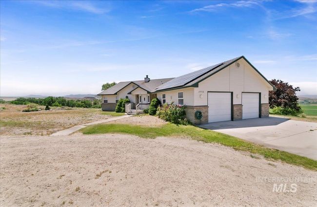 Ranch-style home with solar panels and brick siding | Image 5