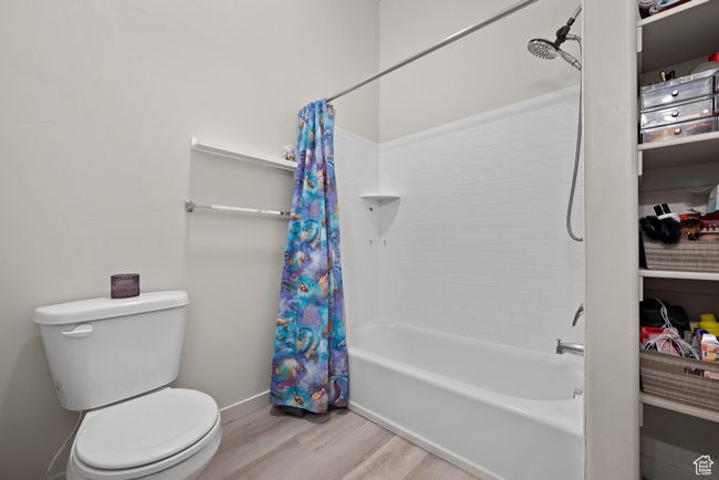 Full bath featuring wood finished floors and shower / tub combo | Image 12