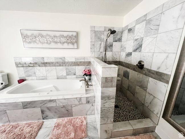 Full bath featuring a marble tile shower and a whirlpool tub | Image 28