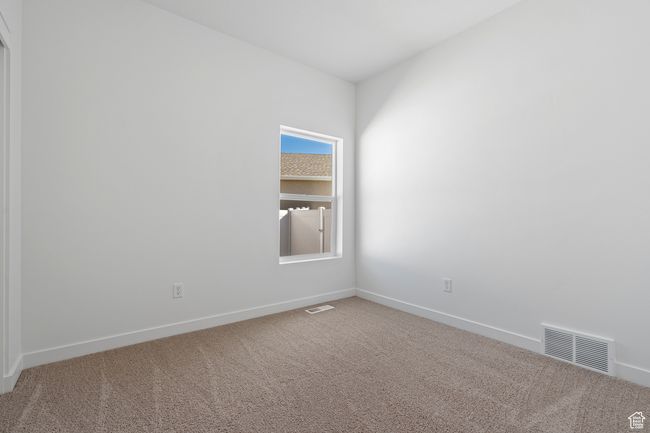 Carpeted empty room featuring visible vents and baseboards | Image 10