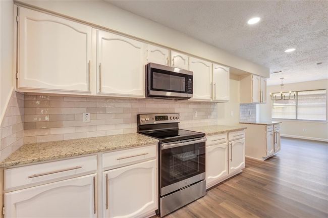 Plenty of cabinet space in this kitchen as well as a large pantry. | Image 9