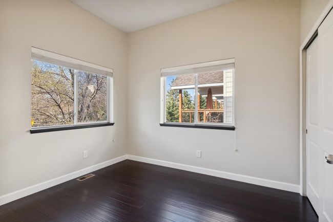 This is the main level bedroom/den/office area. It has fresh paint, high ceilings, and oversized windows. Beautiful! | Image 20