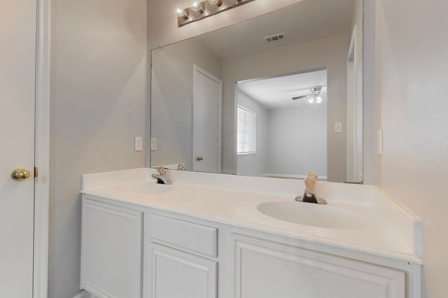 Bathroom featuring double vanity, visible vents, ceiling fan, and a sink | Image 24