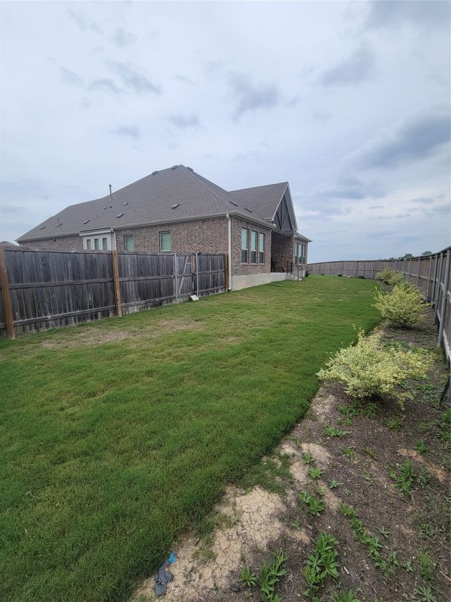 View of back yard featuring a fenced backyard | Image 15