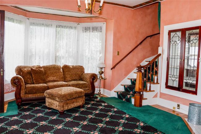The Living Room area with built-ins, a bay window, and plenty of sunshune | Image 13