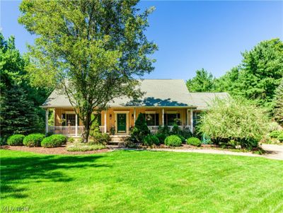 View of front of home with a spacious front porch and yard | Image 1