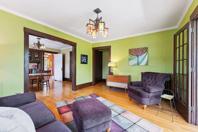 Living room - the entrance to the unit is in the middle of the photos along with a coat closet. The sunroom is to the right of this photo and the dining room is the left. | Image 4