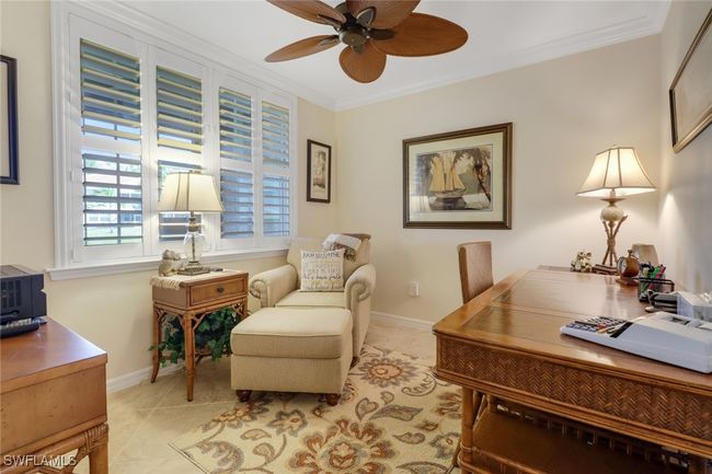 Office area featuring light tile patterned floors, ornamental molding, baseboards, and a ceiling fan | Image 12
