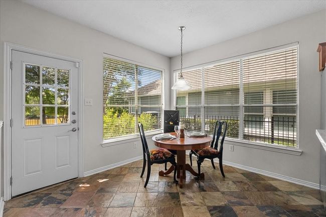 Enjoy meals in the eat in kitchen with large windows offering plenty of natural light. | Image 12