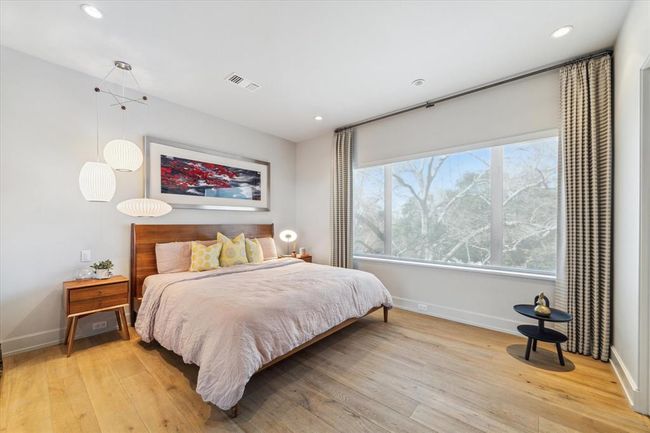 One of the three upstairs bedrooms, this room features an ensuite bath and a generously sized custom closet, maximizing both space and functionality. Ideal for guests or family members seeking privacy and comfort. | Image 29