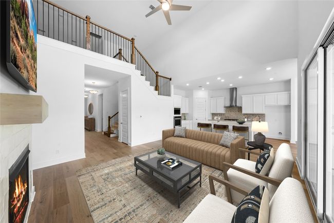 Living room featuring high vaulted ceiling, stairway, recessed lighting, a ceiling fan, and a tile fireplace | Image 8