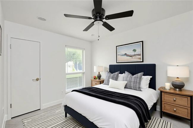 Bedroom with light tile patterned floors, baseboards, and a ceiling fan | Image 16