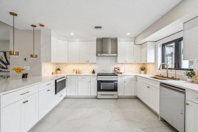 Kitchen featuring with stainless steel Appliances, backsplash, white Custom made cabinetry | Image 5
