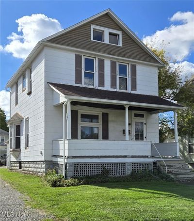 View of front of property featuring a front lawn and a porch | Image 1