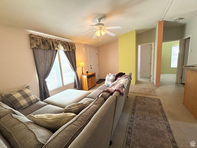 Living area with a ceiling fan and light colored carpet | Image 22