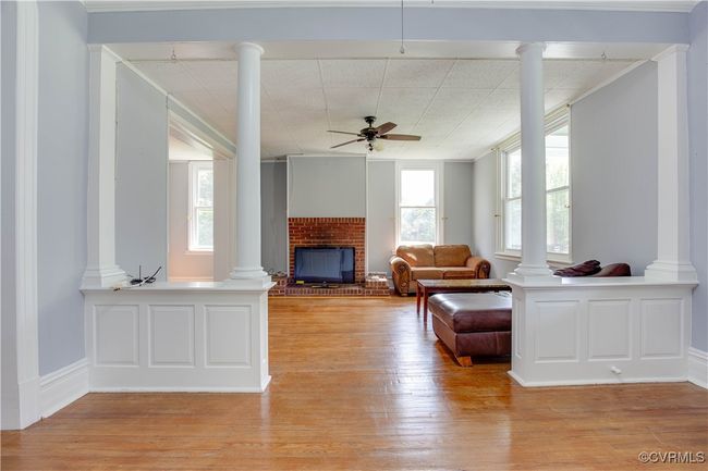 Hall featuring light wood finished floors, ornate columns | Image 11